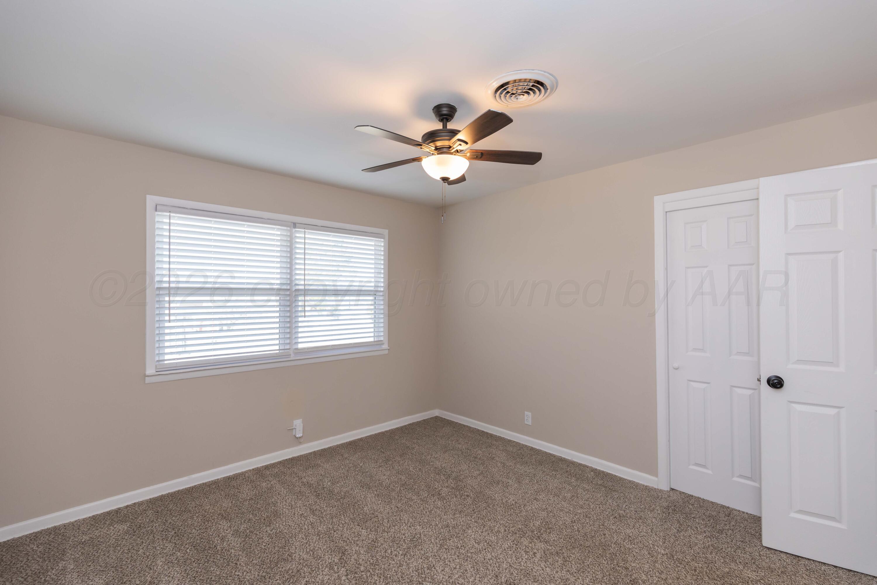 105 Smith Street Borger, TX 79007 - Photo 18 of 26 a view of an empty room with a window