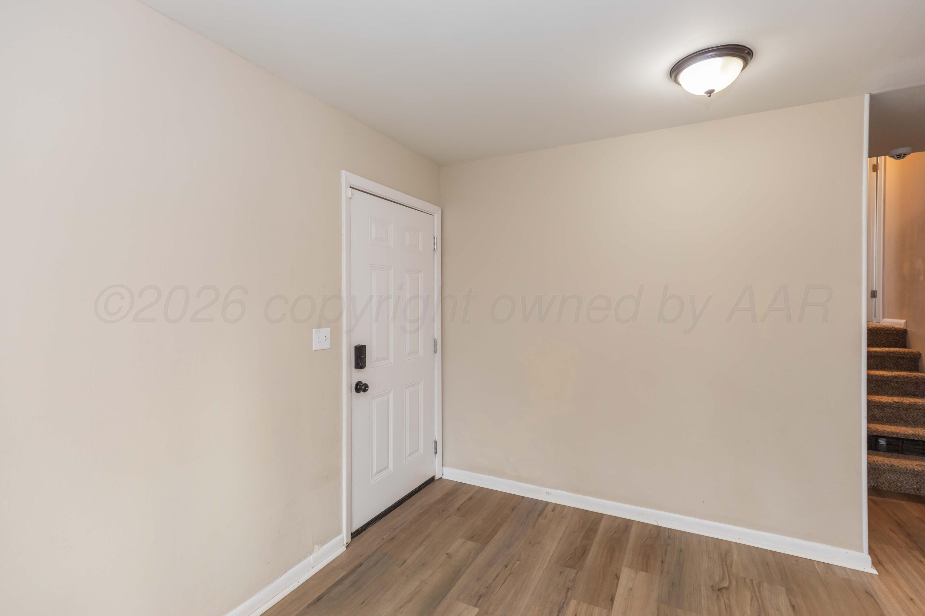 105 Smith Street Borger, TX 79007 - Photo 3 of 26 a view of an empty room with wooden floor