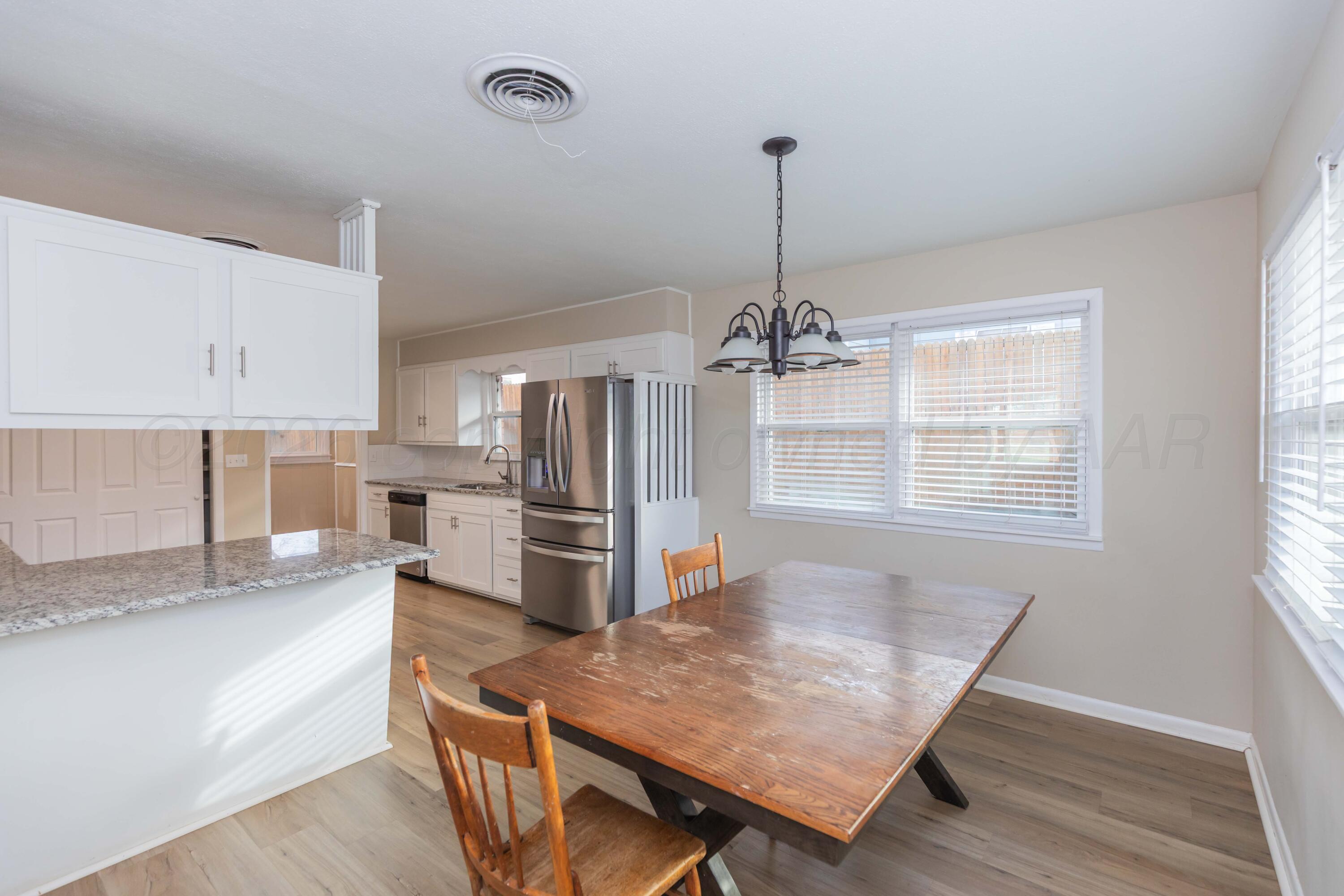 105 Smith Street Borger, TX 79007 - Photo 6 of 26 a view of a kitchen with a table and chairs