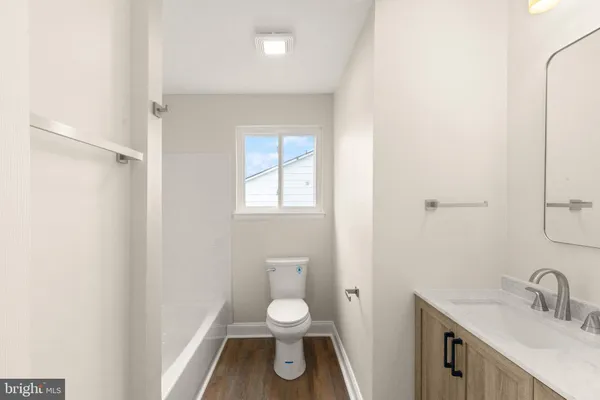 a bathroom with a toilet a sink and a window