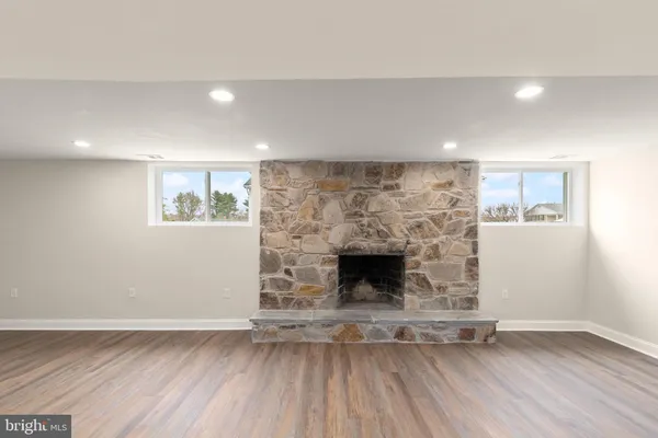 a view of interior space with wooden floor and window