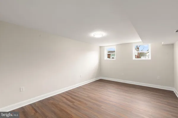 a living room with furniture a flat screen tv and a large window
