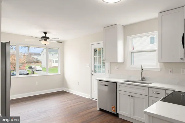 a view of a kitchen with a sink cabinet and a window