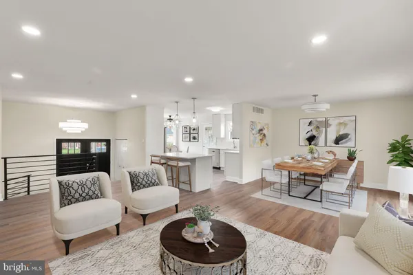 a living room with furniture and a wooden floor