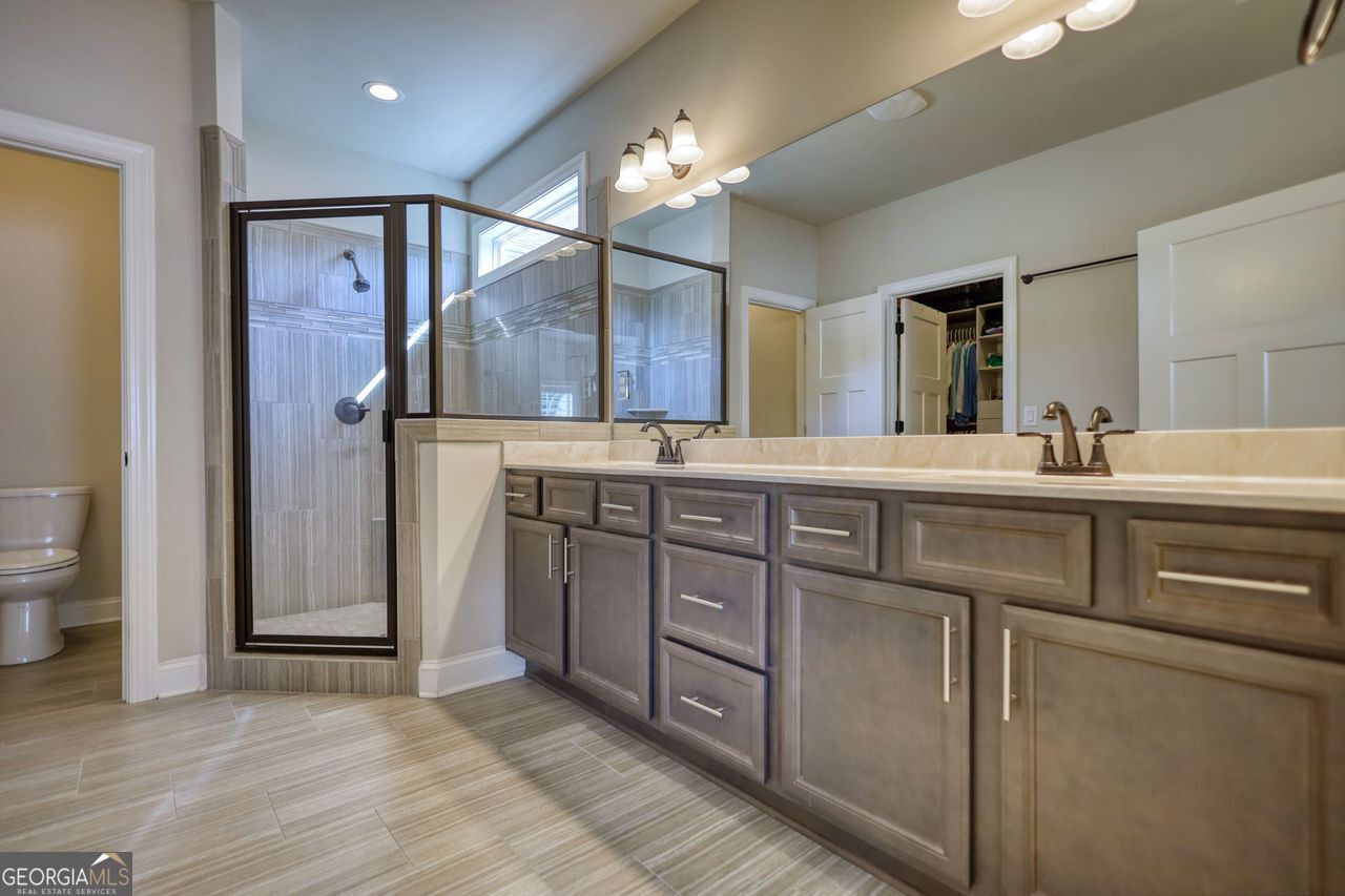 246 Club Drive Monroe, GA 30655 - Photo 13 of 18 a bathroom with a sink and a mirror