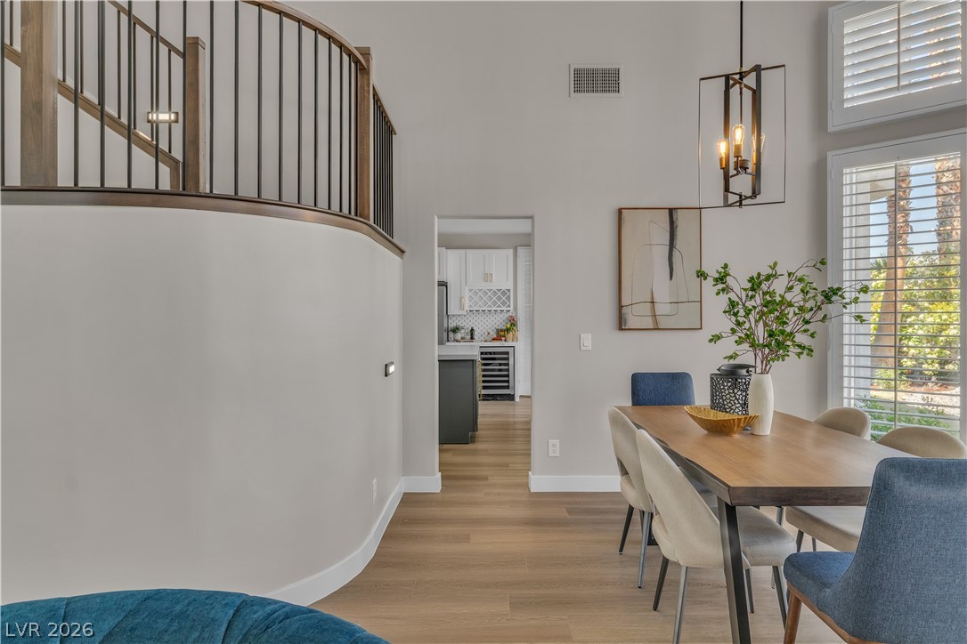 8848 Rainbow Ridge Drive Las Vegas, NV 89117 - Photo 43 of 43 An open floorplan seamlessly connects the dining area to a well-appointed kitchen and elegant staircase.