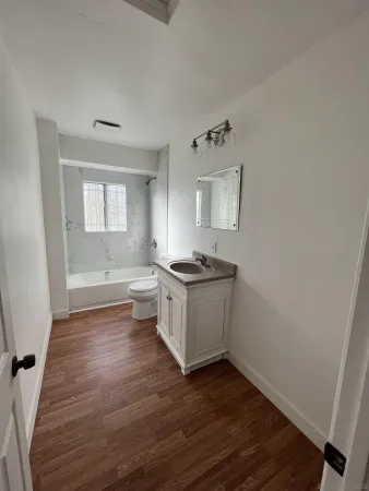 a kitchen with wooden floors and white appliances