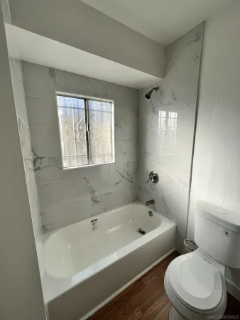 a white bath tub sitting next to a white toilet