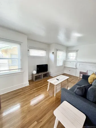 a living room with furniture and a flat screen tv