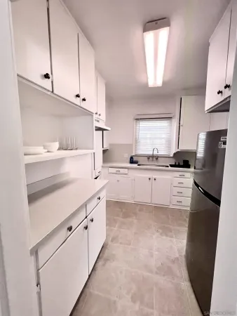 a kitchen with stainless steel appliances granite countertop a refrigerator sink and cabinets