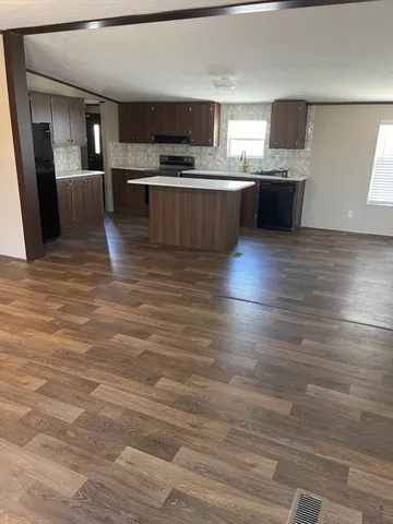 a large kitchen with cabinets a sink and a stove