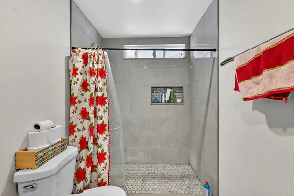 a bathroom with a granite countertop sink mirror vanity and toilet