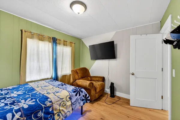 a bedroom with a bed and a couch