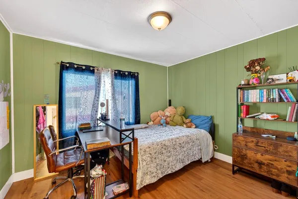 a bedroom with a bed and a window