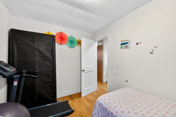 a bedroom with bed and a window