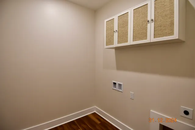 a view of a room with wooden floor ceiling fan and a window