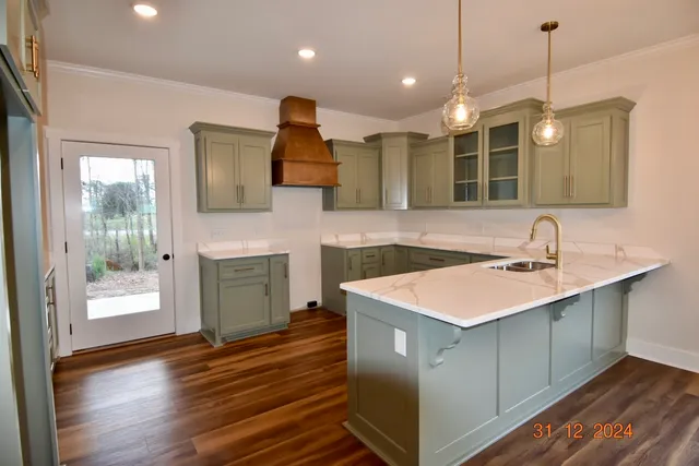 a kitchen with kitchen island a sink stainless steel appliances and cabinets