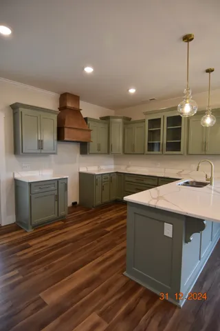 a kitchen with kitchen island a sink stainless steel appliances and cabinets