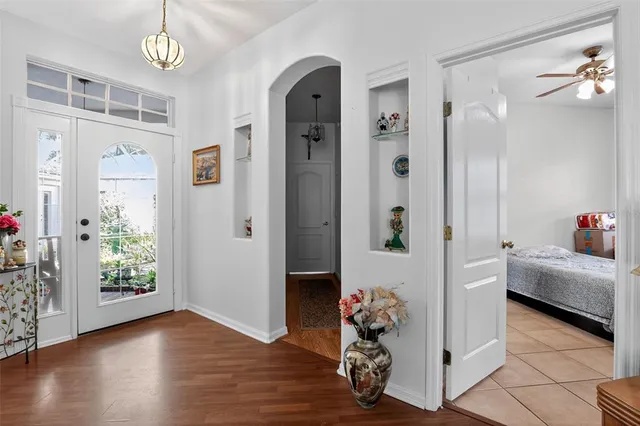 a very nice looking room with wooden floor and a window
