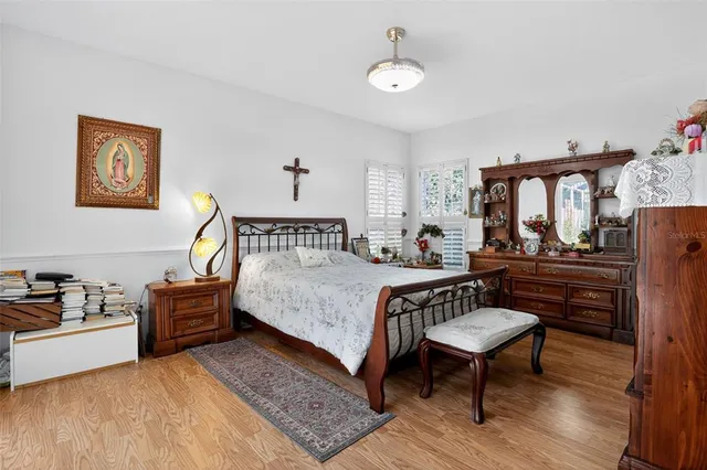 a bedroom with a bed and a dresser in it