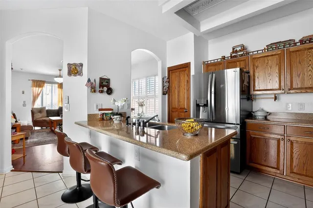 a kitchen with stainless steel appliances granite countertop a sink and a refrigerator