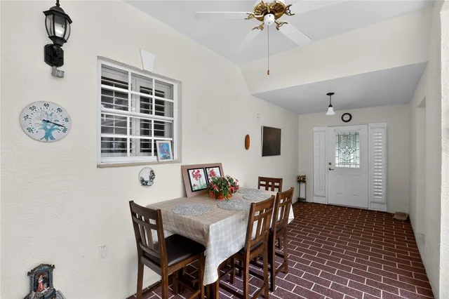 a view of a dining room with furniture and chandelier