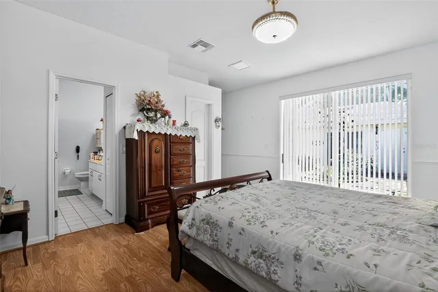 a bed room with a bed mirror and a window