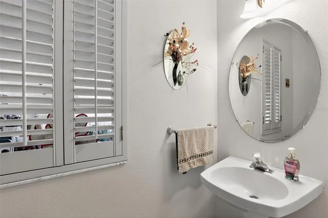 a bathroom with a sink and mirror