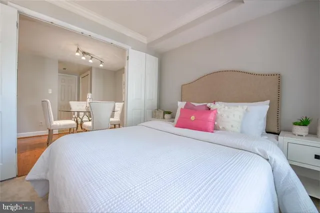 a bedroom with a bed and a night stand