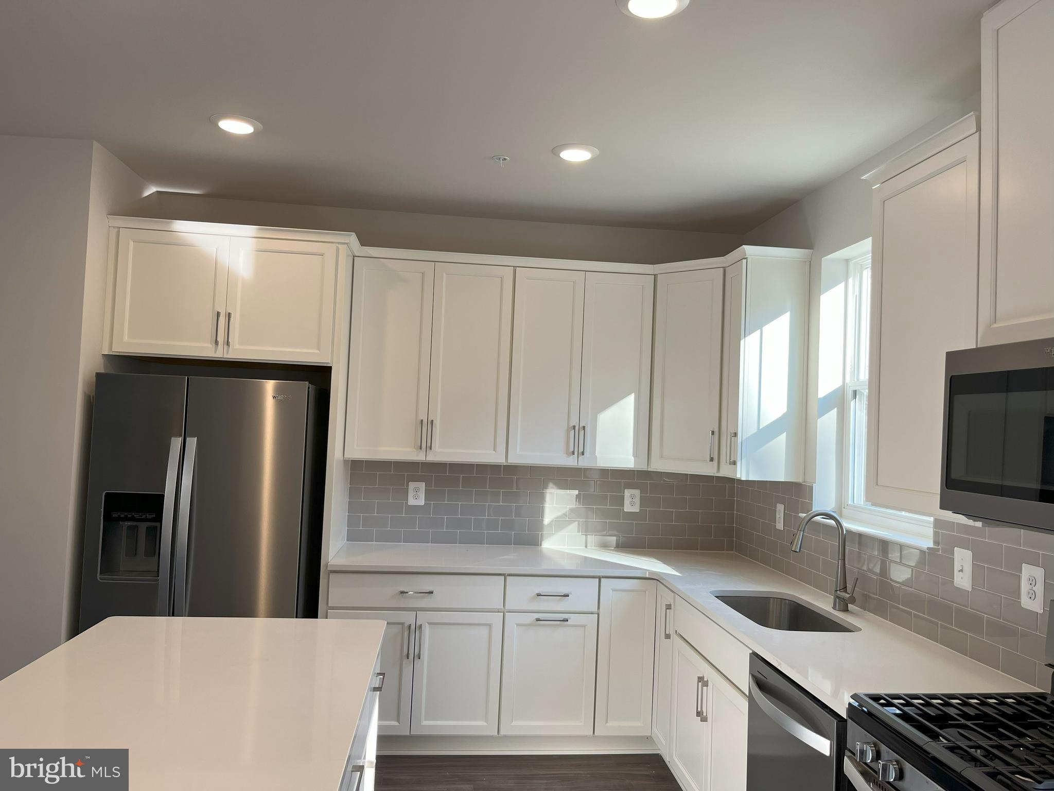 45 Four Leaf Drive Downingtown, PA 19335 - Photo 3 of 16 a kitchen with stainless steel appliances a sink cabinets and a refrigerator