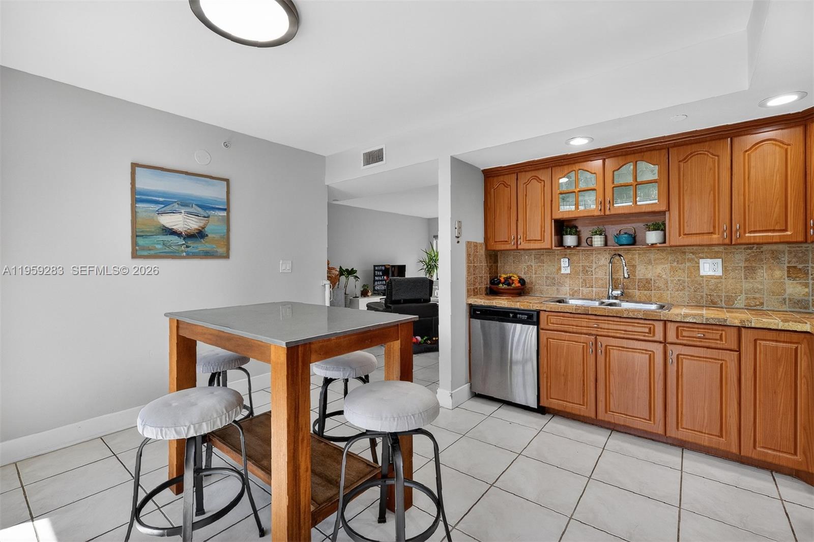 8540 Southwest 133rd Avenue Road, Unit 112 Miami, FL 33183 - Photo 11 of 23 a kitchen with stainless steel appliances granite countertop a stove a sink dishwasher and cabinets with wooden floor