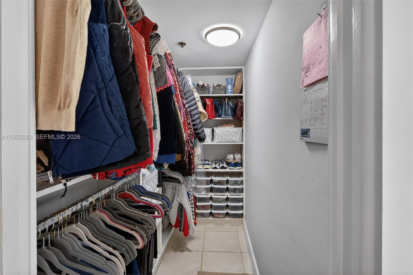 8540 Southwest 133rd Avenue Road, Unit 112 Miami, FL 33183 - Photo 17 of 23 a view of walk in closet with clothes and shoes