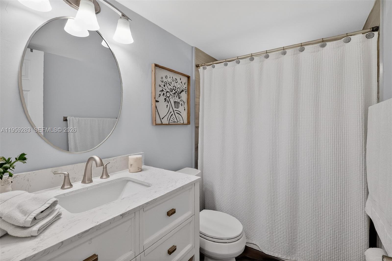 8540 Southwest 133rd Avenue Road, Unit 112 Miami, FL 33183 - Photo 19 of 23 a bathroom with a sink a toilet and a mirror