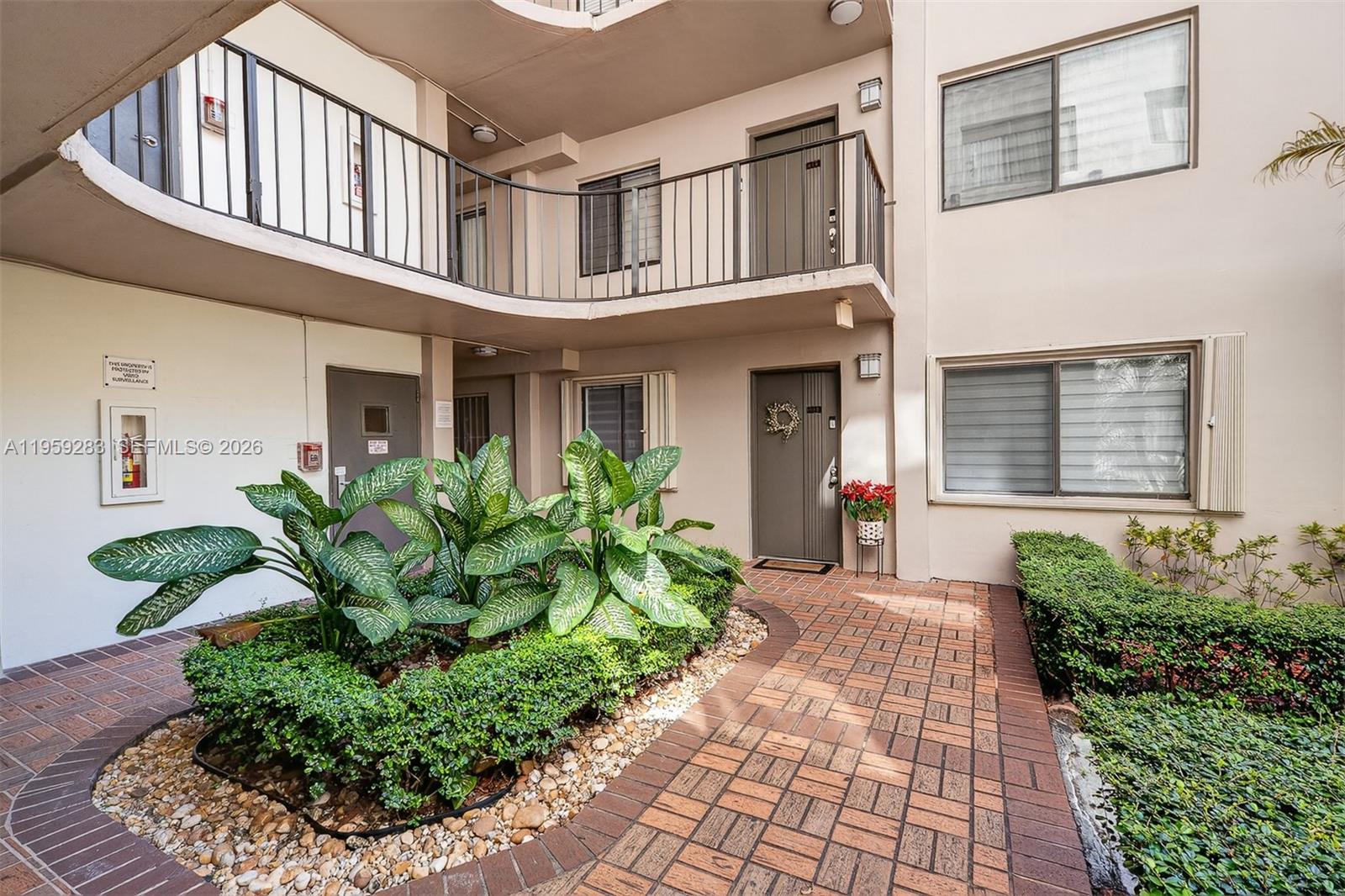 8540 Southwest 133rd Avenue Road, Unit 112 Miami, FL 33183 - Photo 2 of 23 a front view of a house with garden