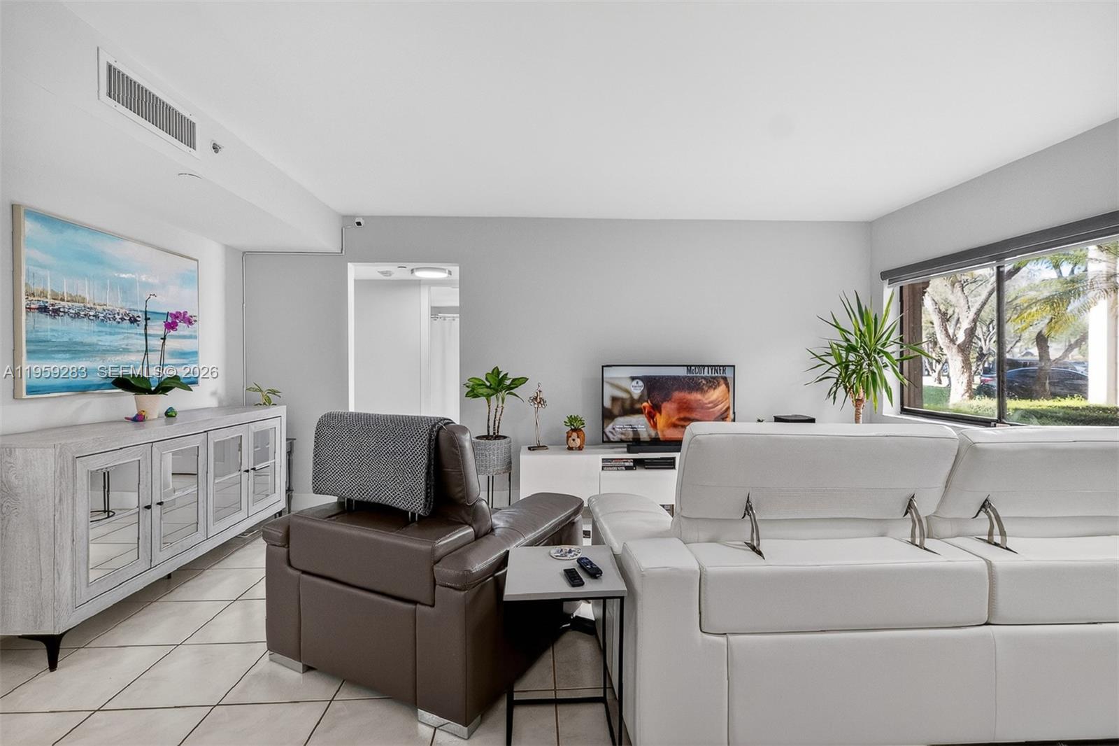 8540 Southwest 133rd Avenue Road, Unit 112 Miami, FL 33183 - Photo 3 of 23 a living room with furniture and a large window