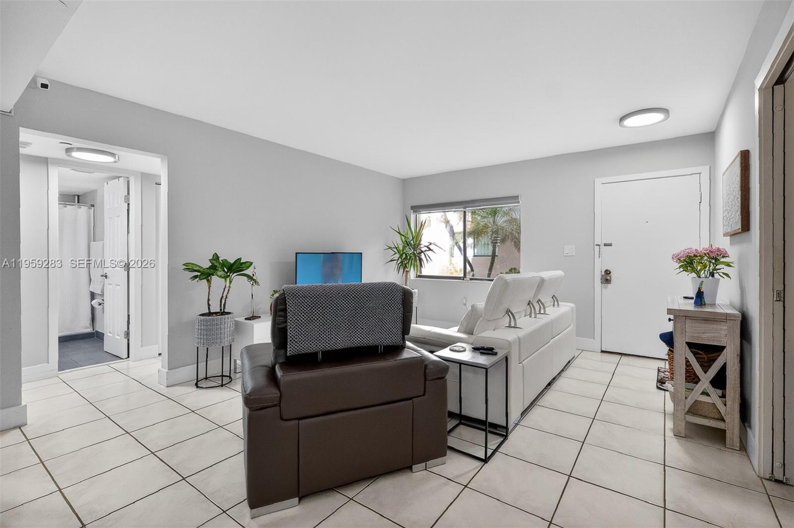 8540 Southwest 133rd Avenue Road, Unit 112 Miami, FL 33183 - Photo 4 of 23 a living room with furniture and a potted plant