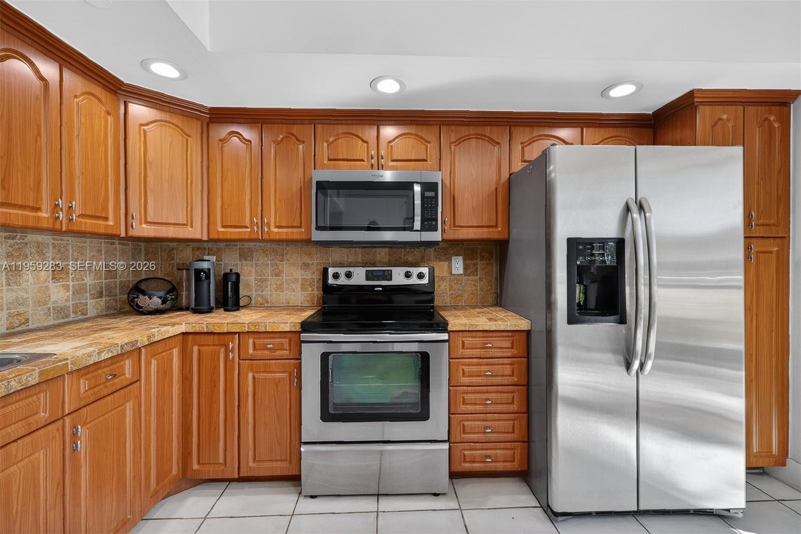8540 Southwest 133rd Avenue Road, Unit 112 Miami, FL 33183 - Photo 8 of 23 a kitchen with stainless steel appliances granite countertop a refrigerator a stove a sink and dishwasher
