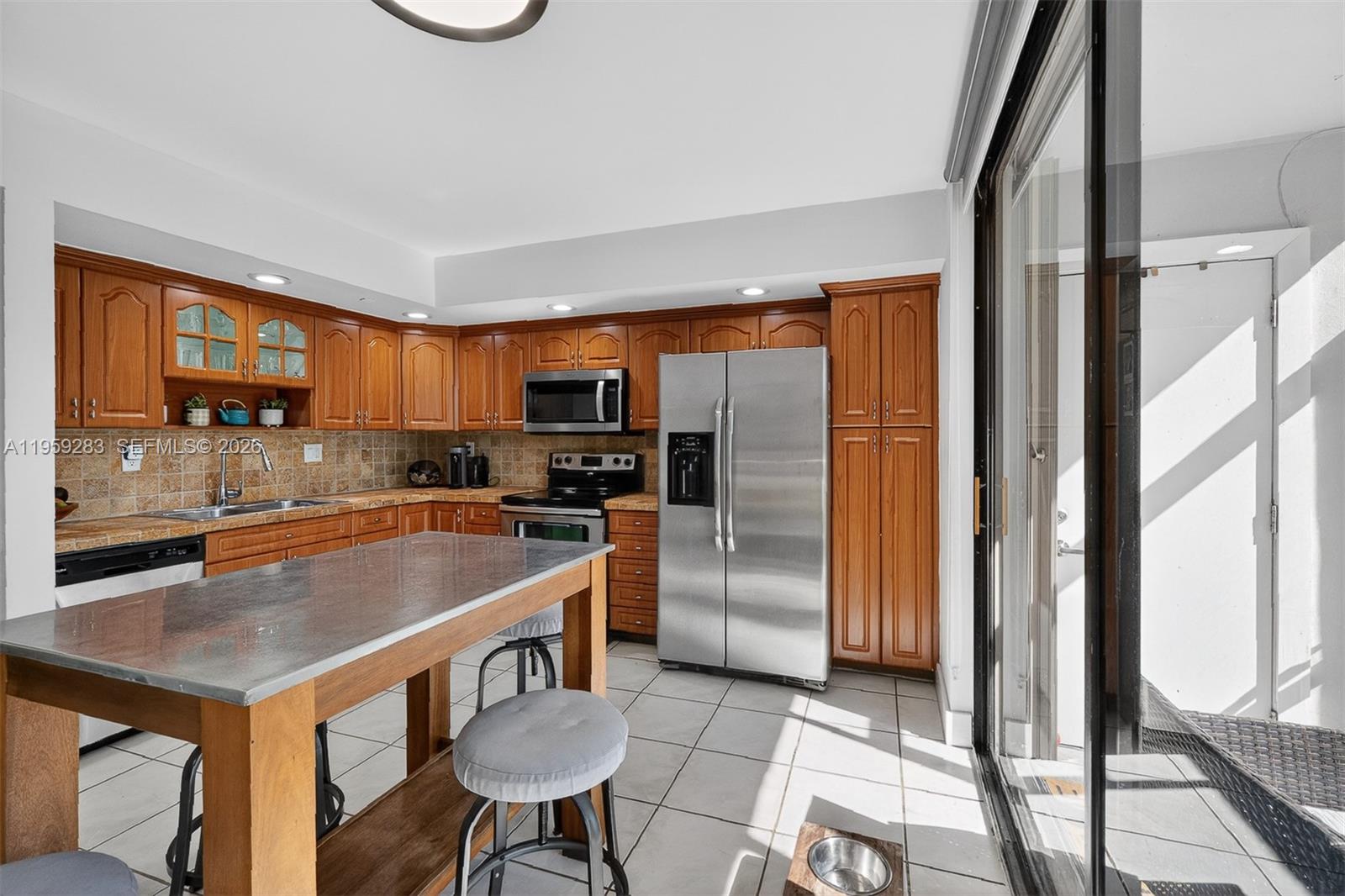 8540 Southwest 133rd Avenue Road, Unit 112 Miami, FL 33183 - Photo 9 of 23 a kitchen with stainless steel appliances granite countertop a sink a stove and a refrigerator