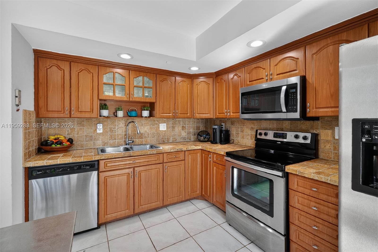 8540 Southwest 133rd Avenue Road, Unit 112 Miami, FL 33183 - Photo 10 of 23 a kitchen with stainless steel appliances granite countertop a stove top oven a sink dishwasher and a microwave