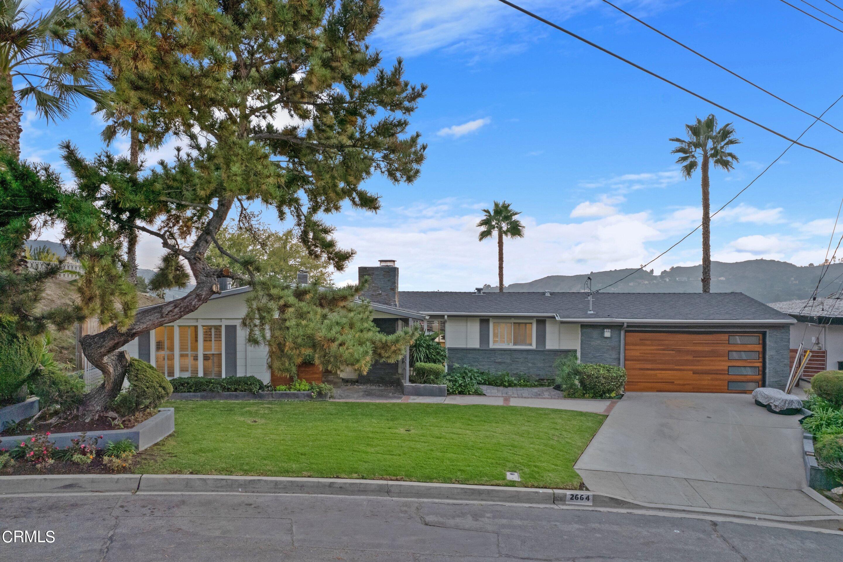 2664 Bogue Drive Glendale, CA 91208 - Photo 2 of 69 a front view of a house with a garden and plants