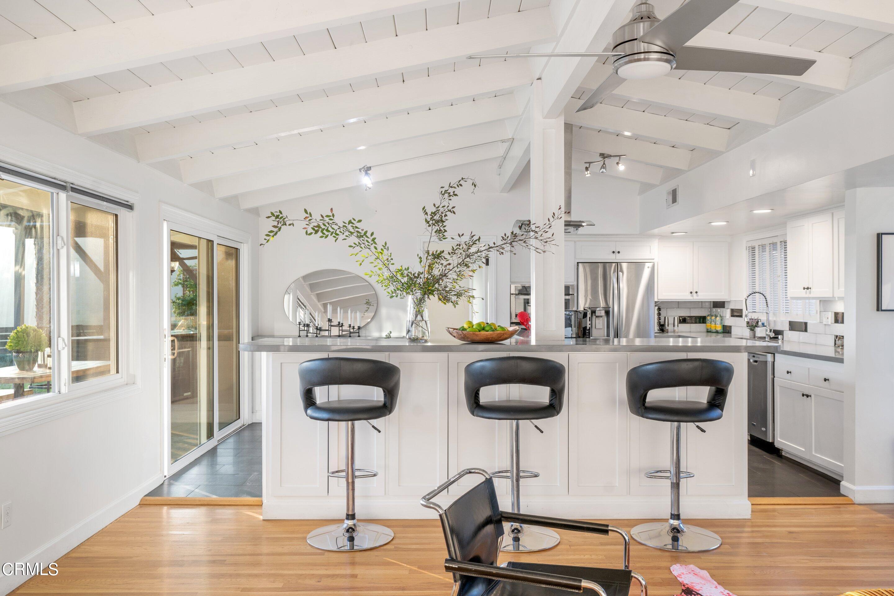 2664 Bogue Drive Glendale, CA 91208 - Photo 14 of 69 a kitchen with stainless steel appliances granite countertop a stove a sink and a dining table with wooden floor