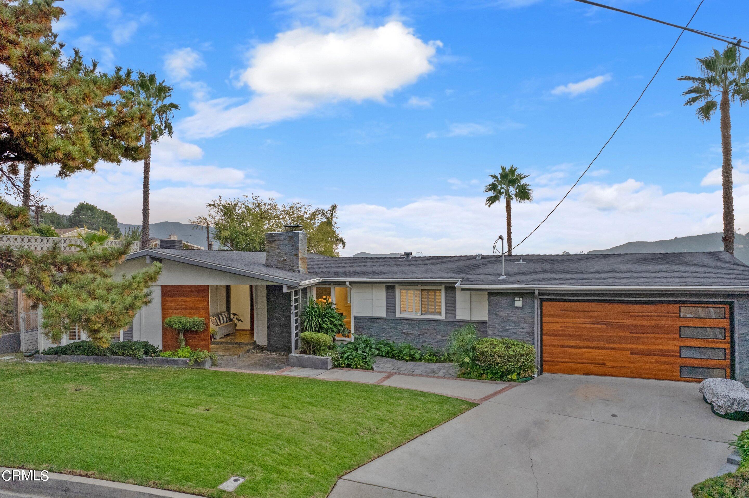 2664 Bogue Drive Glendale, CA 91208 - Photo 3 of 69 a front view of a house with a garden and yard