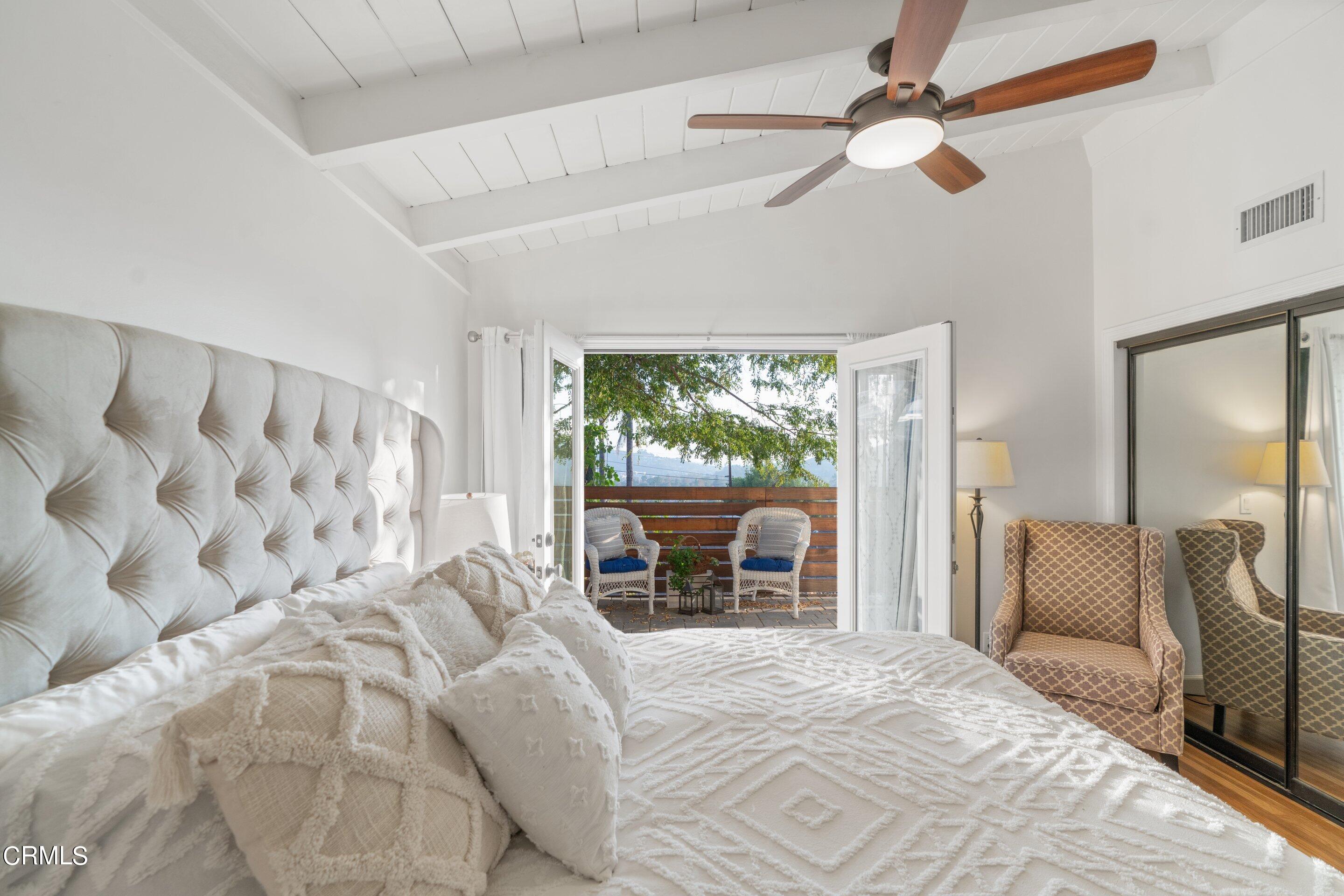 2664 Bogue Drive Glendale, CA 91208 - Photo 35 of 69 a bedroom with a large bed and a chandelier