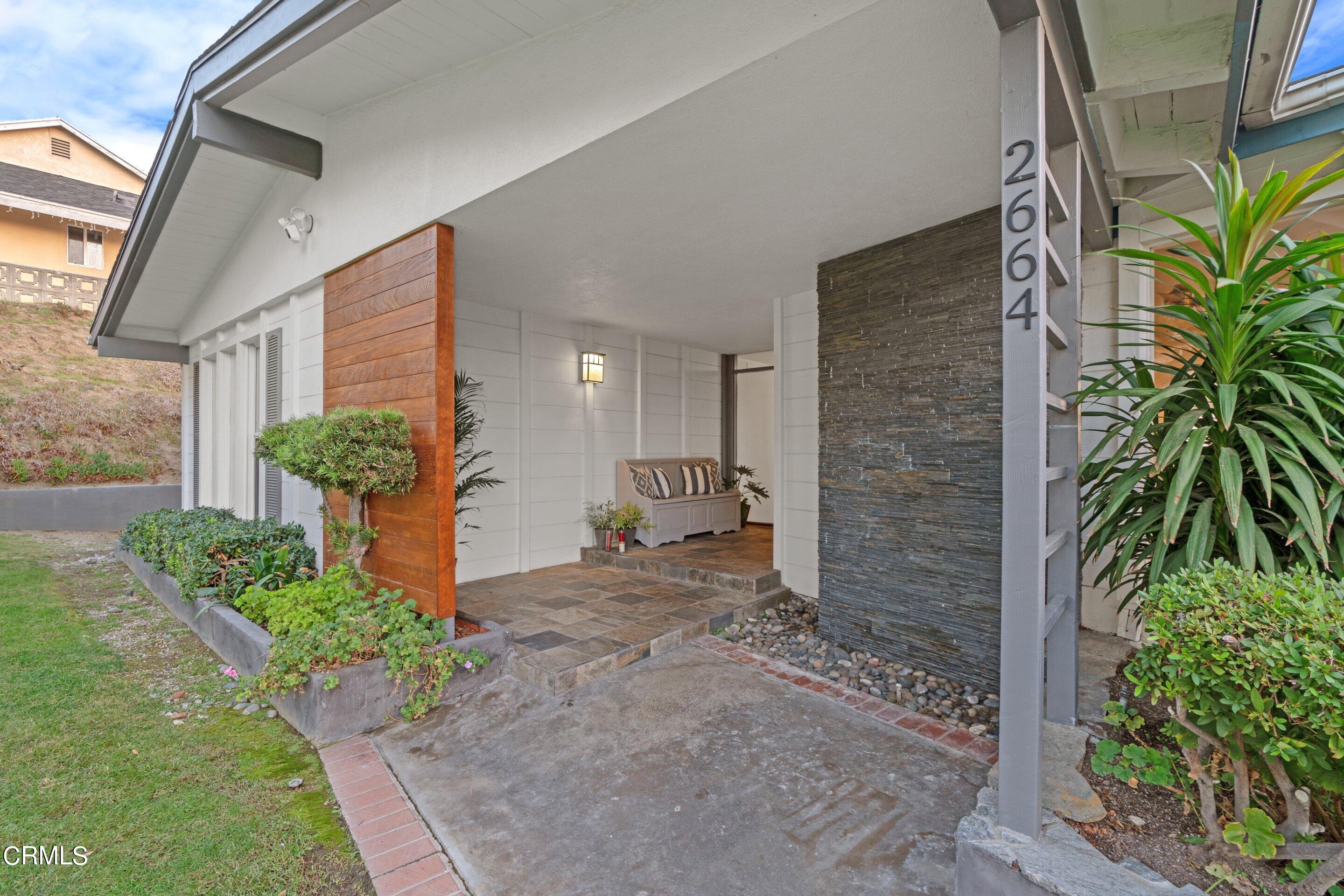 2664 Bogue Drive Glendale, CA 91208 - Photo 6 of 69 a brick house with potted plants in front of door