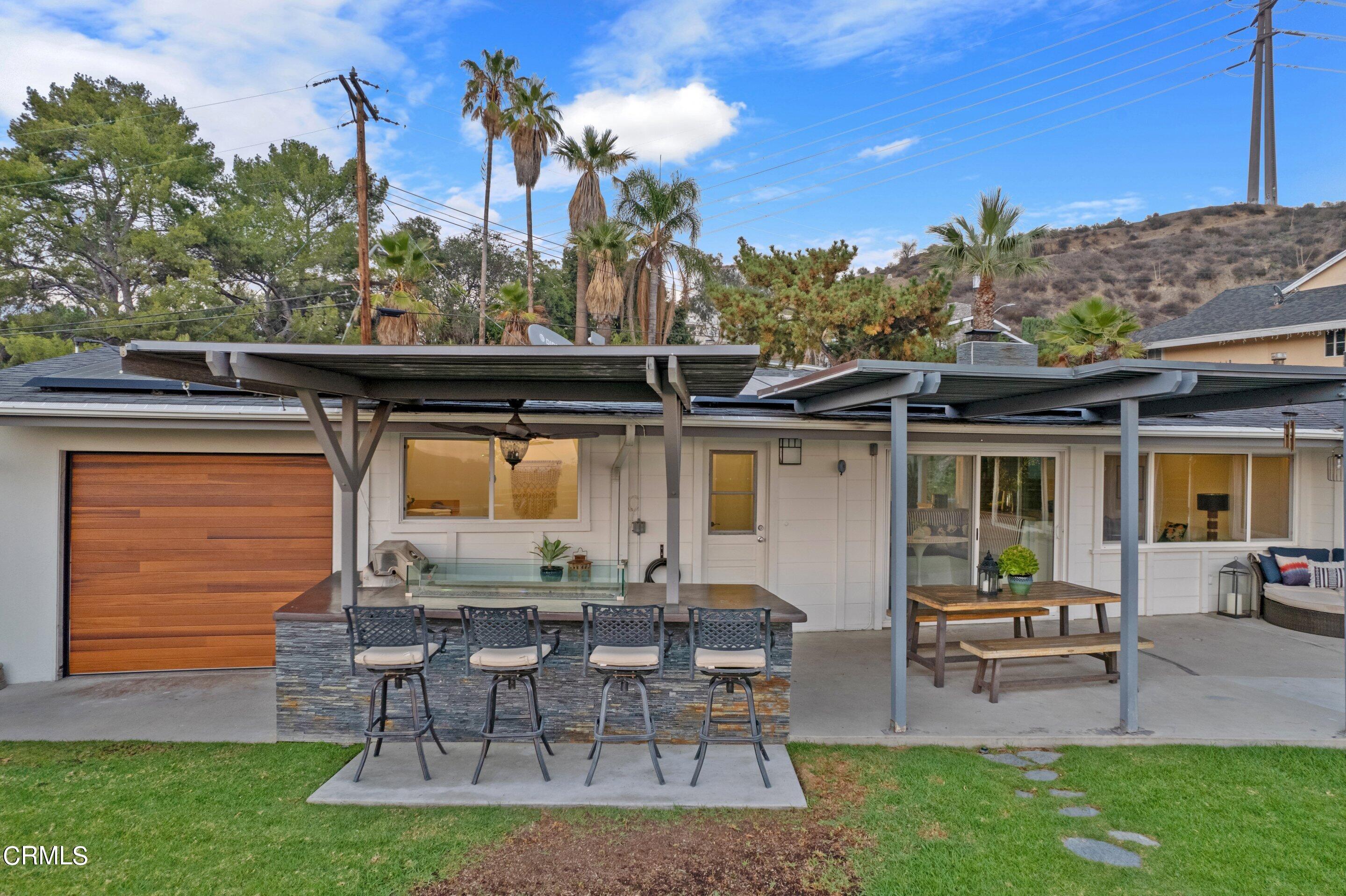 2664 Bogue Drive Glendale, CA 91208 - Photo 63 of 69 a view of a patio with table and chairs potted plants and a large tree