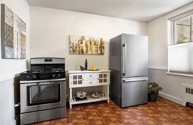 a kitchen with a stove top oven and refrigerator