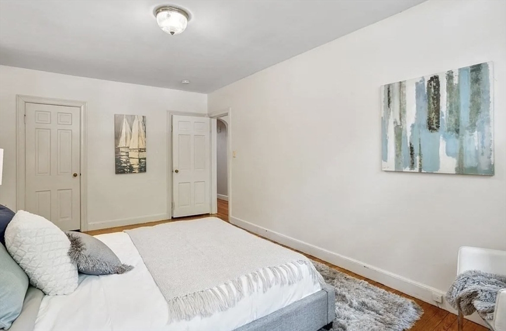 60 Sutherland Road, Unit 1 Boston, MA 02135 - Photo 16 of 21 a bedroom with a bed and a window