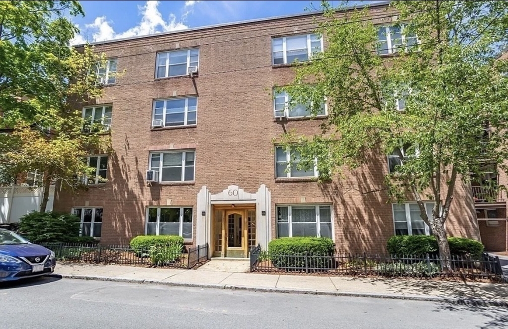 60 Sutherland Road, Unit 1 Boston, MA 02135 - Photo 21 of 21 front view of a brick house with a yard