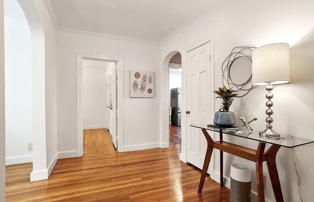 60 Sutherland Road, Unit 1 Boston, MA 02135 - Photo 5 of 21 a view of a livingroom with furniture and wooden floor