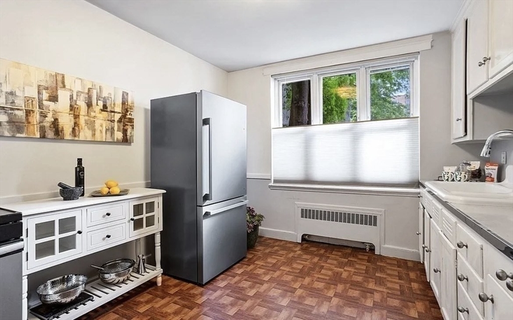 60 Sutherland Road, Unit 1 Boston, MA 02135 - Photo 9 of 21 a kitchen with stainless steel appliances a refrigerator sink and cabinets